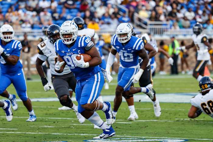 Sep 17, 2022; Durham, North Carolina, USA; Duke Blue Devils defensive tackle DeWayne Carter (90) runs with the fumbled football to score a touchdown during first half against North Carolina A&T Aggies at Wallace Wade Stadium. Mandatory Credit: Jaylynn Nash-USA TODAY Sports  